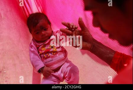 Gopal Kishan 16 Plays With His Four Month Old Baby Alok While Sitting Outside His Wife S House Near Baran Located In The Northwestern State Of Rajasthan January 21 13 Gopal Was Married To His