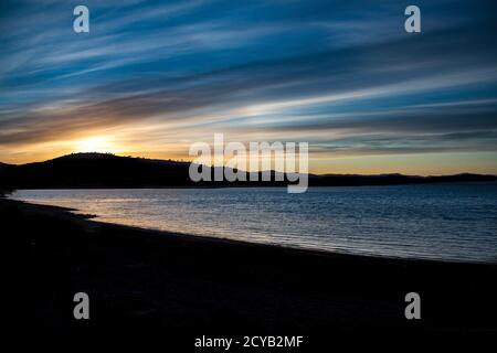 L'aube surplombe le barrage de Hume, traverse la rivière Murray, en Nouvelle-Galles du Sud, en Australie avec le soleil se levant derrière le sommet de la colline, ciel doré Banque D'Images