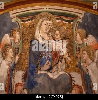 Fresque de la Vierge et de l'enfant avec deux anges, dans le Sacro Speco à Subiaco, Latium, un bel exemple de fresque gothique médiévale. Banque D'Images