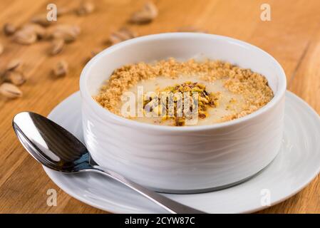 Desserts turcs lait puding; Keskul, sutlac sur bois Banque D'Images