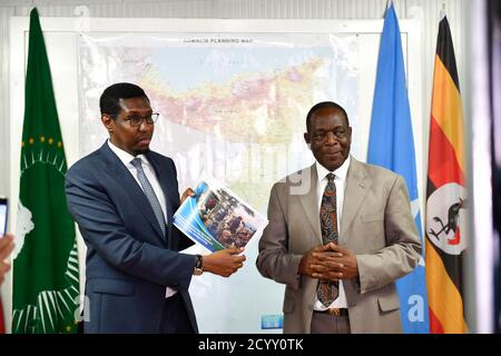 L'Ambassadeur Francisco Madeira (à droite), le Représentant spécial du Président de la Commission de l'Union africaine (CSRC) pour la Somalie, remet un exemplaire du Rapport d'évaluation de l'état de préparation opérationnelle des forces régionales somaliennes à Mohamed Abukar Islow Dualle (à gauche), Le Ministre fédéral somalien de la sécurité intérieure lors d'une cérémonie qui s'est tenue à Mogadiscio le 26 février 2019. Banque D'Images