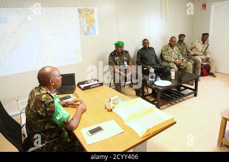 Le colonel Hassan Chla, commandant adjoint de l'AMISOM du secteur 2, présente une délégation de la composante police de la Mission de l'Union africaine en Somalie (AMISOM) dirigée par Rex Dundun, le chef d'état-major de la police de l'AMISOM qui est également le commissaire de police par intérim de l'AMISOM, Au cours du déploiement des officiers de police (IPO) servant dans le cadre de l'AMISOM, à Dhobley (Somalie), le 25 mars 2019. Banque D'Images