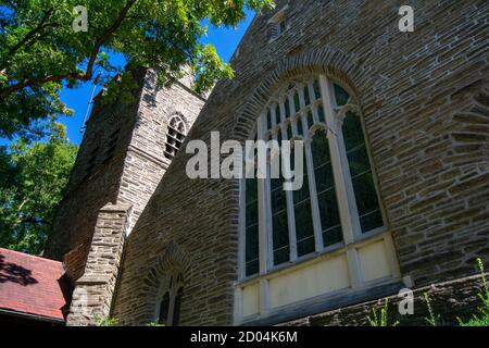 Une grande fenêtre de vitraux sur une église Cobblestone dans Banlieue de Pennsylvanie Banque D'Images