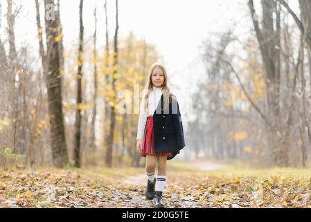 Enfant à pied dans le parc d'automne. Petite fille dans la rue Banque D'Images