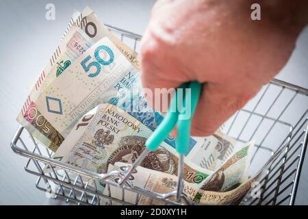 Panier rempli d'argent de Pologne. Le concept de la hausse des prix dans les magasins et de l'inflation Banque D'Images