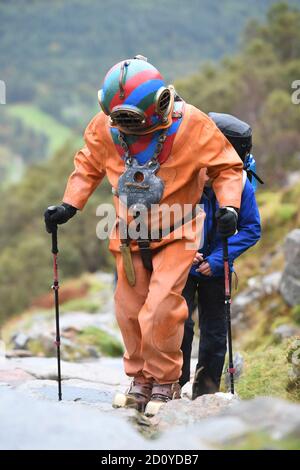 Lloyd Scott, collecteur de fonds vétéran, qui tente de grimper les trois sommets, tout en portant un costume de plongée en haute mer, lors de son défi sur Ben Nevis en Écosse. Banque D'Images