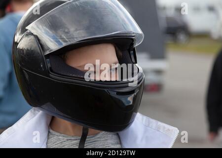 Umea, Norrland Suède - 30 août 2020 : petit gars avec casque de moto sur le circuit Banque D'Images