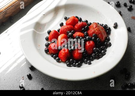 Cassis et fraises dans une assiette. Banque D'Images