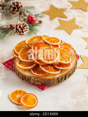 Tranches d'orange séchées sur un plateau en bois couronne d'arbre de Noël et étoiles dorées. Banque D'Images