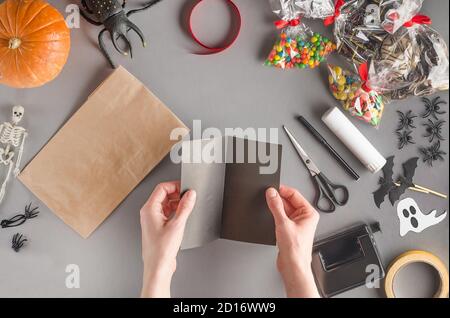 Emballage étape par étape d'un cadeau pour Halloween. Étape 5 - obtenir le toit en papier noir pour la maison Banque D'Images