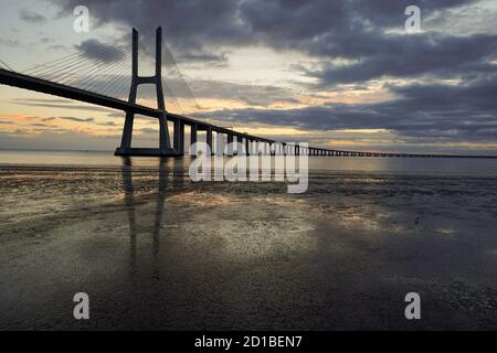 Pont de Lisbonne. Le pont Vasco da Gama est un beau point de repère et l'un des plus longs ponts du monde. Paysage urbain au lever du soleil. Le Portugal Banque D'Images