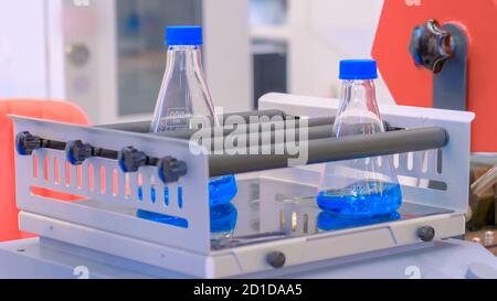 Chimie, pharmaceutique, concept d'équipement de laboratoire. Agitateur orbital pour le mélange, l'agitation et le mélange d'échantillons biologiques dans des flacons en plastique en pharmacie Banque D'Images