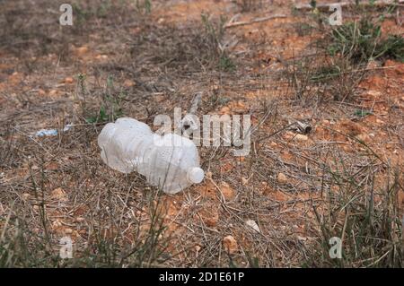 Déchets sous la forme d'une bouteille en plastique transparent qui rend l'environnement sale en se dégradant au fil du temps Banque D'Images