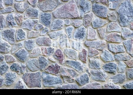 Texture de mur en pierre grise et bleue, arrière-plan de l'ancien sol. Sol naturel en pierre, motif. Surface de brique, cadre. Graftez la structure en ciment. Un élément d'arche Banque D'Images