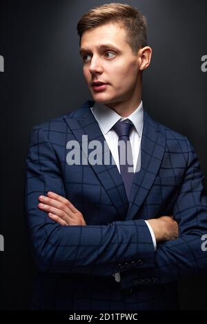 jeune homme d'affaires sérieux en chemise de costume noir classique posant isolé sur fond noir, réalisation carrière richesse concept d'affaires, tournage en studio Banque D'Images