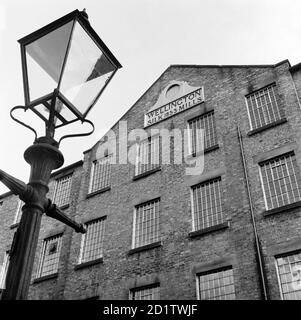 WELLINGTON MILLS, rue Strangman, Leek, Staffordshire. Vue extérieure montrant la section en relief avec une lampe standard au premier plan. Aux XVIIe et XVIIIe siècles, Leek était célèbre pour sa production de soie d'une qualité exceptionnelle. Lorsque cette usine a été construite en 1853, l'importation de soie française et italienne en Grande-Bretagne était illégale depuis 25 ans. La levée de cette interdiction a eu un effet catastrophique sur les travailleurs de la soie dans des domaines comme celui-ci. Photographié par Eric de Mare en 1956. Banque D'Images