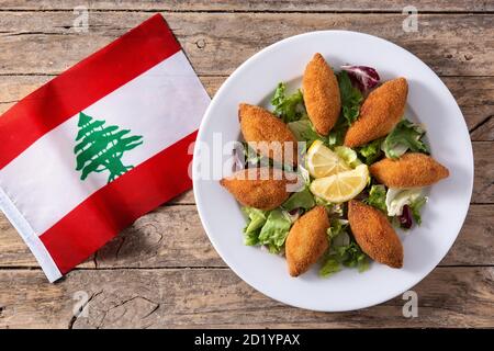 Kibbeh libanais traditionnel et drapeau libanais sur table en bois Banque D'Images
