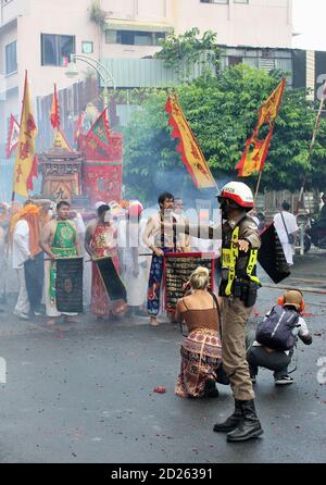 Phuket Town / Thaïlande - 7 octobre 2019 : Festival végétarien de Phuket ou défilé du Festival des neuf dieux de l'empereur, avec un policier dirigeant la circulation Banque D'Images