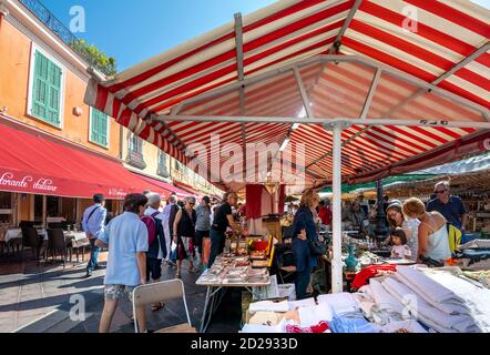 Les touristes apprécient le marché aux puces couvert en plein air hebdomadaire au cours Saleya, dans la vieille ville de Nice, en France. Banque D'Images