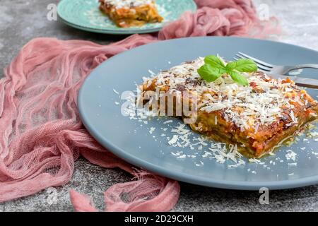 Parmigiana di Melanzane - lanières d'aubergines frites au parmesan, cuites dans une sauce tomate dans une casserole en céramique Banque D'Images