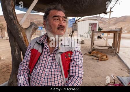 San José, Chili. 06e octobre 2020. Jorge Galleguillos, l'un des mineurs secourus il y a dix ans, est assis à côté de l'ancienne mine de San José où les mineurs ont été enterrés. Le monde entier a été dans une fièvre d'excitation lorsque les 33 mineurs ensevelis de la mine dans le désert d'Atacama ont été amenés à la surface dans une opération de sauvetage spectaculaire. Plus d'un milliard de personnes ont suivi le « miracle du Chili » en direct à la télévision. (À dpa 'dix ans après le sauvetage: Les copains chiliens se sentent oubliés') Credit: Alex F. Catrin/dpa/Alamy Live News Banque D'Images