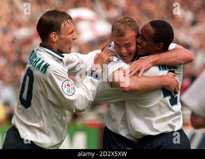 Les coéquipiers Teddy Sheringham (à gauche) et Paul Ince (à droite) se précipitent pour féliciter Alan Shearer après son but d'ouverture dans le match de championnat européen 96 d'aujourd'hui (samedi) contre la Suisse, à Wembley. Photo par Adam Butler/PA Banque D'Images