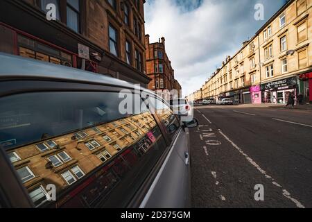 Duke Street à Dennistoun se reflète dans la fenêtre de voiture, Glasgow, Écosse, Royaume-Uni Banque D'Images