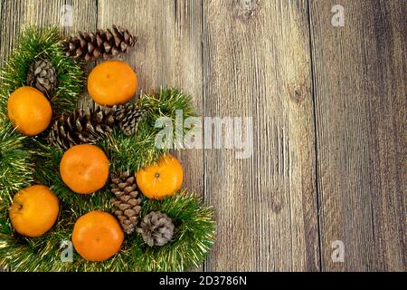 Ambiance de Noël avec mandarines et décoration de noël isolée sur le arrière-plan en bois Banque D'Images