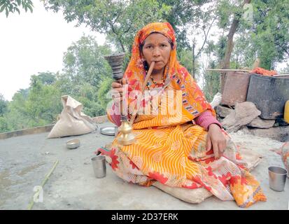 Dans les zones rurales de Nainital, les femmes fument aussi à égalité avec les hommes. Cependant, pas de cigarettes ni de bidis, le narguilé est largement utilisé ici. Banque D'Images