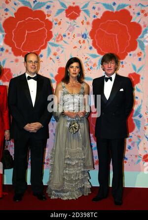 Princess Caroline (C) smiles as she arrives surrounded by her brother Prince Albert of Monaco (L) and her husband Prince Ernst August of Hanover (R) to attend the Bal de la Rose in Monte Carlo March 20, 2004. The Bal de la Rose is a traditional and annual charity event in Monaco Principality. REUTERS/Eric Gaillard  EG/CRB