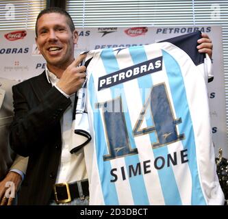 Argentine midfielder, 34-year-old Diego Simeone shows a Argentine Racing  Club soccer club jersey in Buenos Aires, December 21, 2004 after signing to  play for the club in the next Argentine First Division Championship.  Simeone, who left Europe after ...