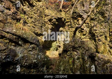 Cavité dans un ancien opencut de l'exploitation minière de plomb, sur le sommet de High Tor à Matlock Bath, plus tard ouvert comme une grotte appelée grotte romaine. Banque D'Images