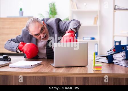 Homme d'affaires furieux et furieux sur son lieu de travail Banque D'Images