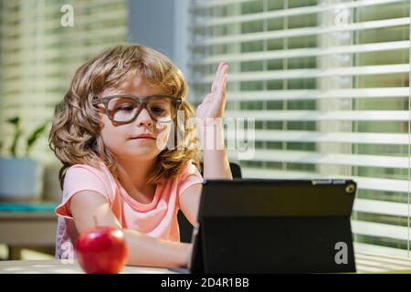 Le jeune garçon lève la main pour répondre à la question des enseignants. Covid-2020. Banque D'Images