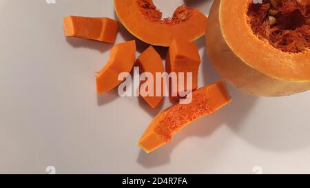 Citrouille mûre en tranches. Morceaux de citrouille. Fond végétal Banque D'Images