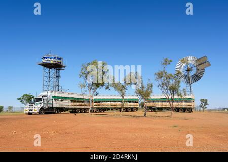 Un train routier ou un camion de bétail est stationné devant une girouette à vent et une tour d'eau décorée, Boulia, Queensland, Queensland, Australie Banque D'Images