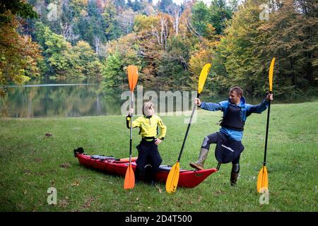 Père et fils s'amusant en kayak rouge après avoir fait du kayak dans une forêt inondée à Rakov skocjan, Slovénie Banque D'Images