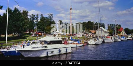 Göta kanal à Karlsborg, avec des bateaux à moteur amarrés et des voiliers le long de cette voie navigable idyllique en Suède. Banque D'Images