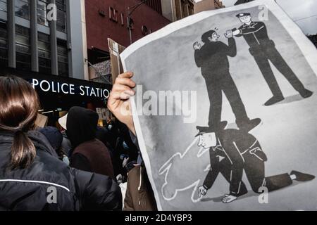 Un manifestant a été vu en train de tenir un écriteau devant le poste de police pendant le rassemblement Black Lives Matter.des milliers de personnes se sont rassemblées au Parlement victorien et dans des villes et des villes du pays pour protester contre la mort de George Floyd à Minneapolis en garde à vue. De nombreux manifestants à Melbourne portaient des masques et utilisaient un désinfectant pour les mains car des restrictions de la phase 3 de la classe 19 étaient en place. Après des discours au Parlement, les manifestants ont marché paisiblement jusqu'à la gare de Flinders Street, où ils se sont rassemblés à l'intersection alors que la nuit tombait. Banque D'Images