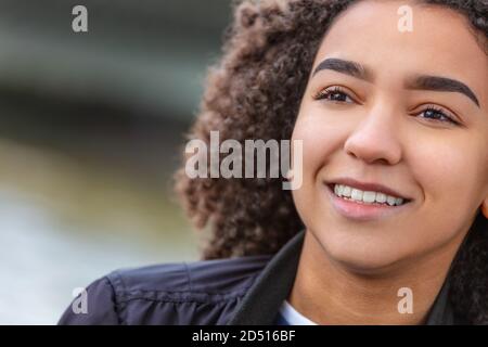 Bonne fille ou jeune femme afro-américaine souriante et mixte avec des dents parfaites Banque D'Images