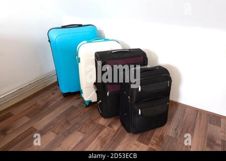 Plusieurs valises ou sacs de voyage dans une rangée près du mur blanc, sacs à bagages modernes pour le tourisme Banque D'Images