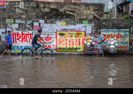 Dhaka, Bangladesh. 12 octobre 2020. Les navetteurs se sont enlatés dans une rue engortée de la route verte de la capitale après de fortes pluies. De nombreuses régions de Dhaka sont engorées par l'eau suite à de fortes pluies mettant en difficulté les piétons et les navetteurs. Crédit : SOPA Images Limited/Alamy Live News Banque D'Images