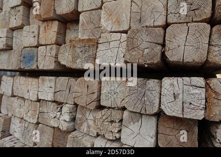 Pile de poteaux en bois carrés sur le chantier de construction. Bois empilés. Banque D'Images