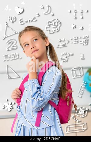 L'école rêveuse en regardant loin près de l'illustration des formules Banque D'Images