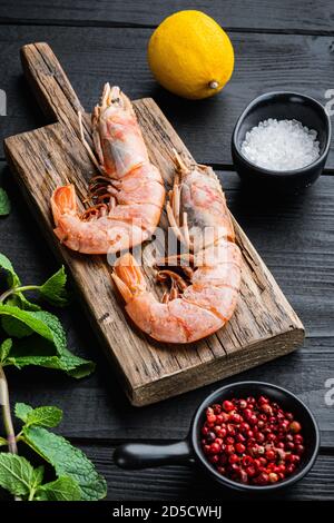 Crevettes géantes sur bois avec herbes sur bois noir arrière-plan Banque D'Images