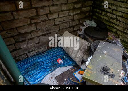 La literie d'un sommeil agitée à Sheffield et il lache ses vêtements et son matériel de cuisine dans les poubelles à côté de son matelas. Banque D'Images