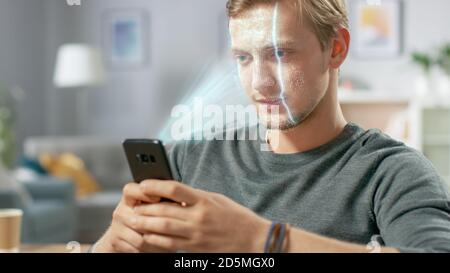 Jeune homme identifié par la reconnaissance faciale biométrique processus de lecture à partir de son smartphone. Concept futuriste : le projecteur identifie l'individu par Banque D'Images