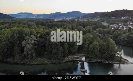 Vue aérienne sur le déversoir de Brugg, Suisse. Barrage de la centrale hydraulique avec affluent de la rivière Aare dans la forêt riveraine. Banque D'Images