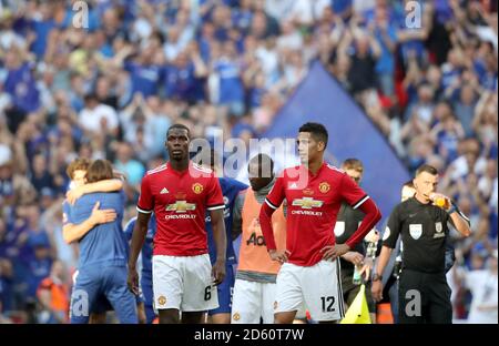 Paul Pogba (à gauche) et Chris Smalling de Manchester United sont découragés après le jeu Banque D'Images