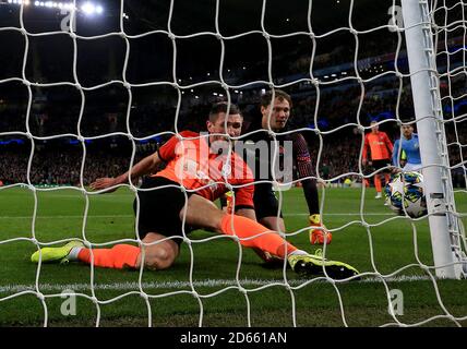 Le Sergiy Kryvtsov de Shakhtar Donetsk se retire de la ligne après que le gardien de but Andrei Pyatov renverse le ballon Banque D'Images